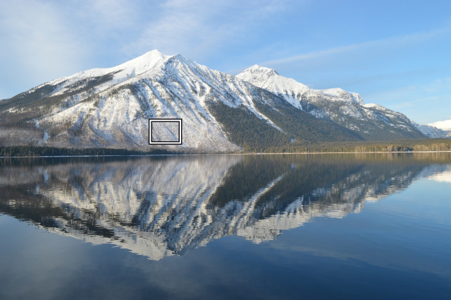 The mountain and lake photo, with a small white and black rectangle marking the detail compared below.